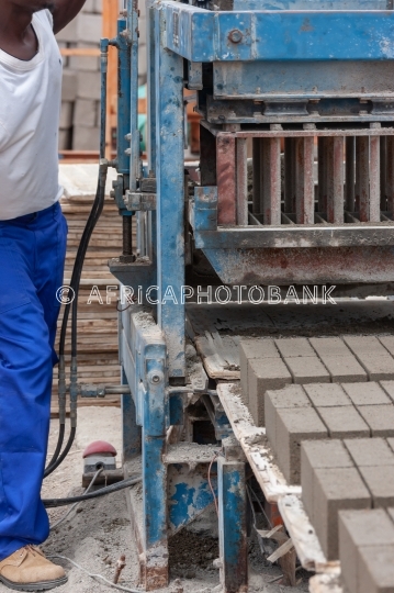 man and bricks machine